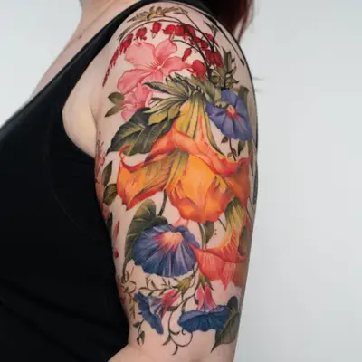 Colorful floral tattoo on upper arm with various flowers