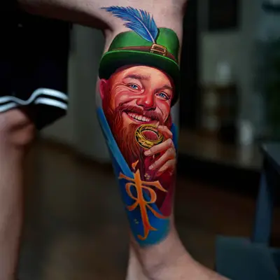 Tattoo of a cheerful man with a beard and green hat holding a ring.