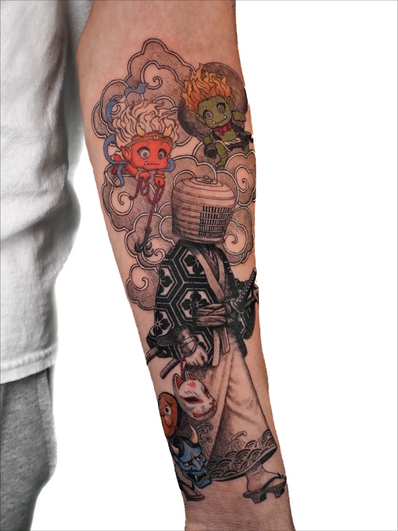 Tattoo of samurai figure with masks and mythical creatures on forearm.