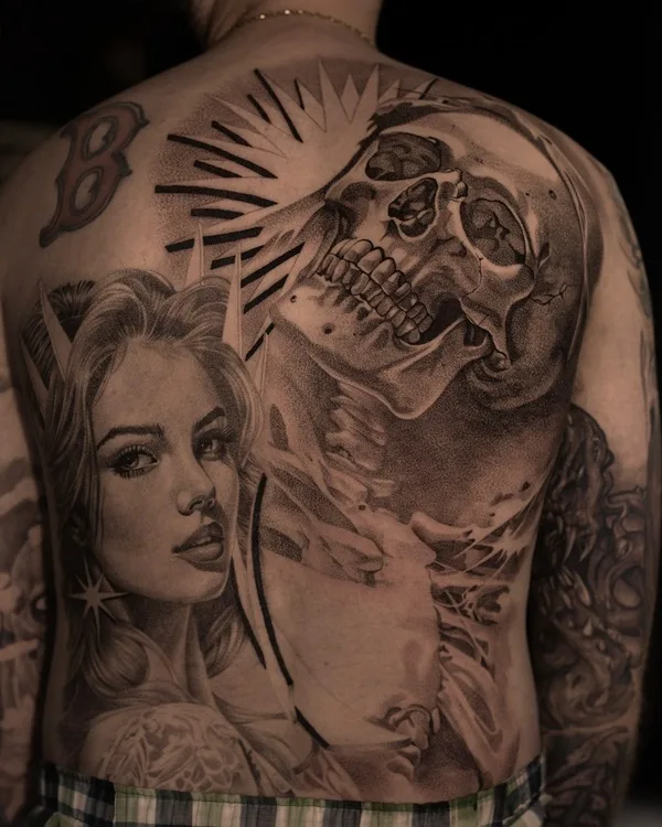 Tattoo of a woman's face and a skull on a man's back.