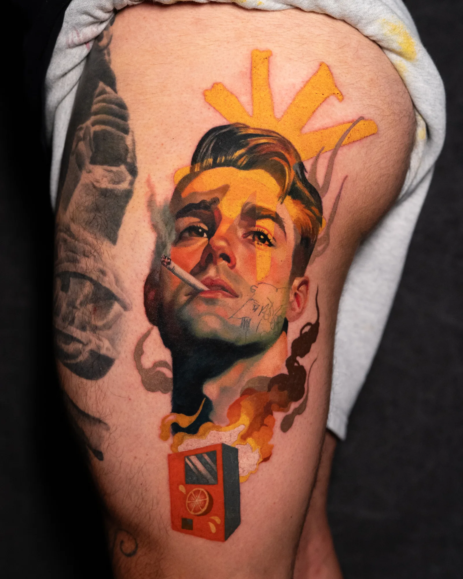 Tattoo of a man smoking with vibrant colors and abstract elements on the leg.