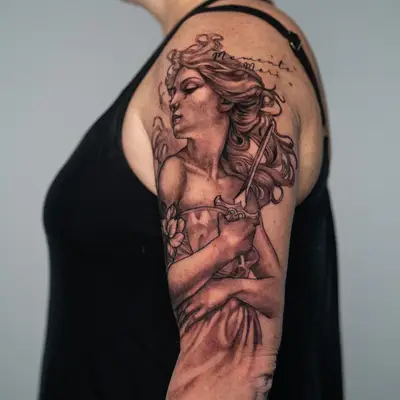 Arm tattoo of a woman with flowing hair and sword.