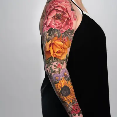 Colorful floral tattoo sleeve with various flowers on arm