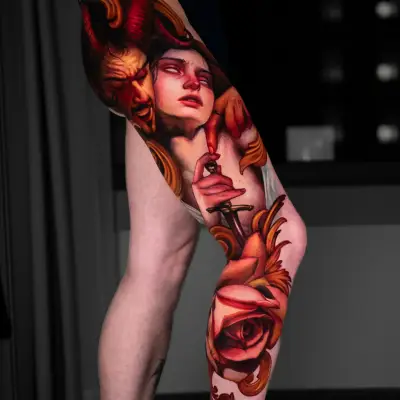 A vivid leg tattoo featuring a devil, a woman, and roses.