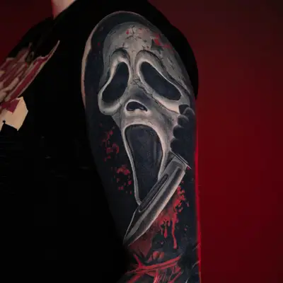 Tattoo of a horror mask with a knife on an arm sleeve