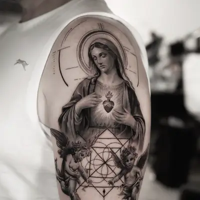 Black and grey half sleeve of the Virgin Mary with the Sacred Heart, a fine-line halo and arch, two cherubs and sacred geometry, with memorial lettering below.