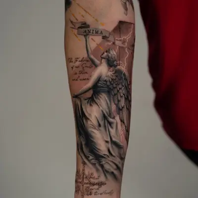 Black and grey realism forearm of a stone angel holding a banner reading ANIMA, with lightning, a cross and script.