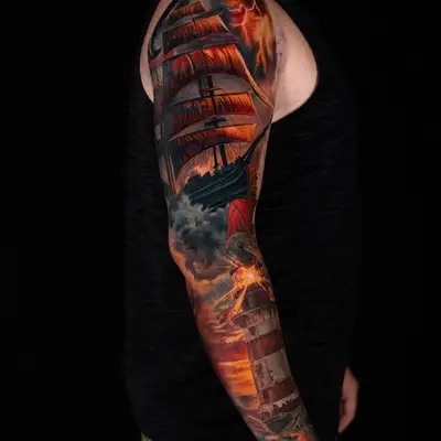 Color realism full sleeve: a tall ship with orange sails in a lightning storm on the upper arm, with clouds opening into a sunset over a red and white lighthouse on the forearm.