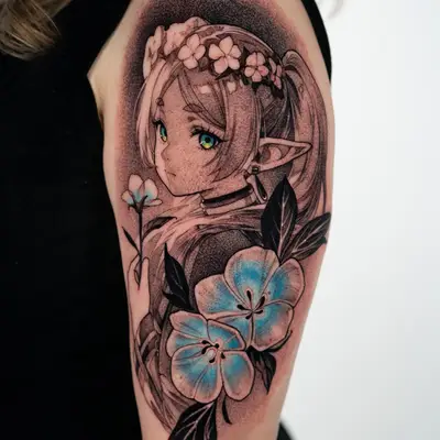 Fusion tattoo on the upper outer arm of the anime elf Frieren with a flower crown and teal eyes, holding a small flower, with two large blue flowers and dark leaves below, set against a stippled halo.