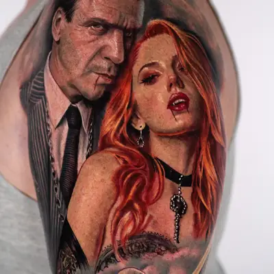 Color realism tattoo on the outer upper arm and shoulder: a stern dark-haired man in a pinstripe suit and chain with blood at his lip, beside a red-haired woman with fangs, blood on her lips, an earring and a black choker, above swirling smoke from which a soldier in a Vietnam-era helmet emerges.