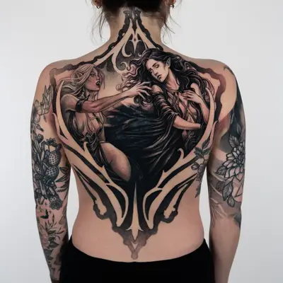 Full back tattoo in black and grey of two elven women inside a tall gothic frame, one with fangs bared reaching toward the other, who leans away with her eyes closed and long dark hair.