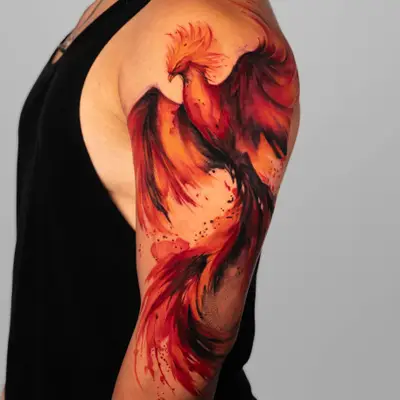 Phoenix tattoo in watercolor style on upper arm