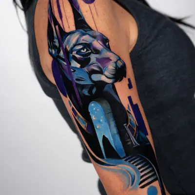 Tattoo of a geometric blue and purple dog with abstract elements.
