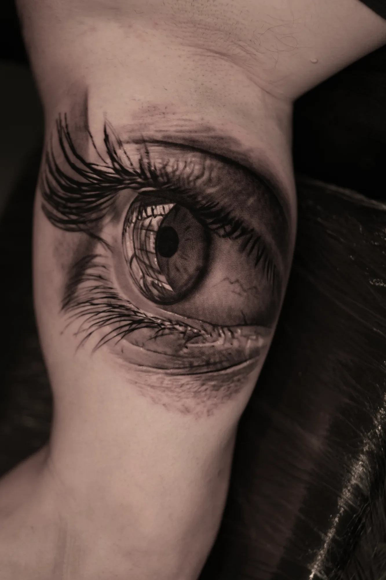 Realistic eye tattoo on inner arm