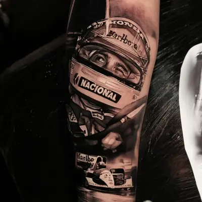 Realistic tattoo of a racing driver and car on an arm.