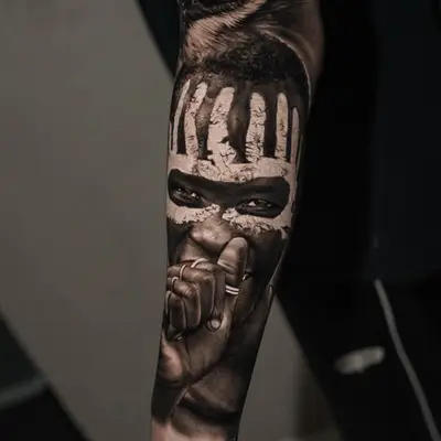 Forearm tattoo with detailed portrait and owl design