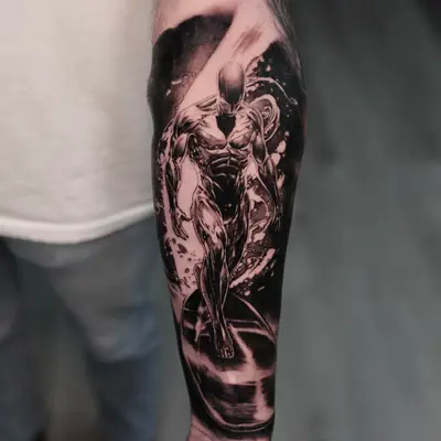 Forearm tattoo of a muscular figure in a dynamic pose, black and grey style.