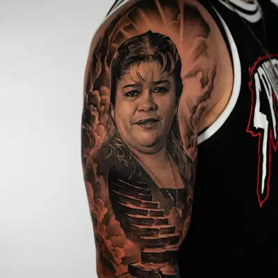 A detailed black and grey tattoo of a woman's portrait with surreal elements.