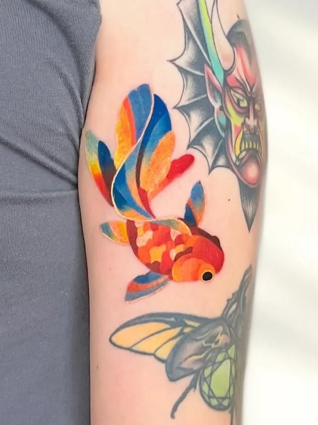 Colorful goldfish tattoo.