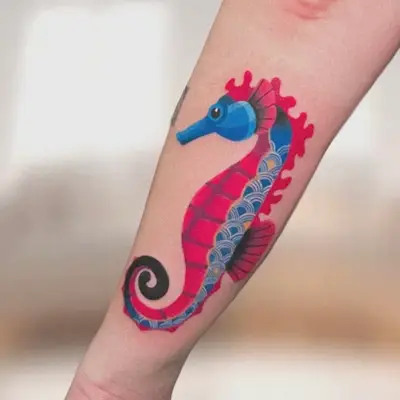 Colorful seahorse tattoo on forearm with geometric patterns