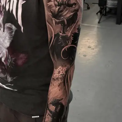 Black and grey Japanese sleeve tattoo with a dragon and samurai.