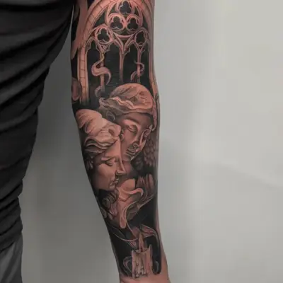 Black and grey tattoo of two angelic figures with candle and stained glass design.