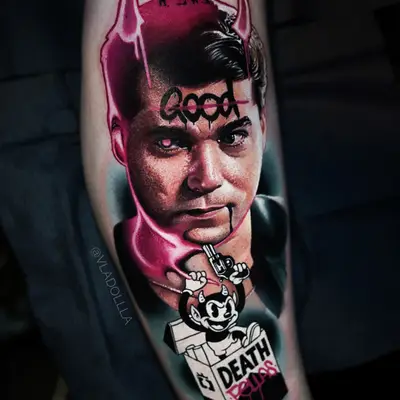 Tattoo of a Ray Liotta from Goodfellas with devil horns, cigarette packet art, and bold text.