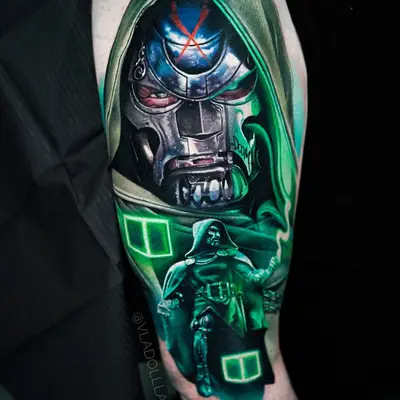 Tattoo of a metallic mask with green accents and a figure in a hooded cloak.