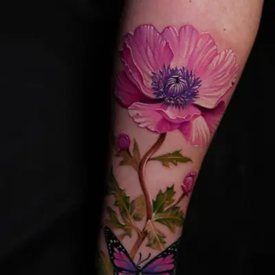Color realism tattoo on the forearm: a large pink flower with a purple center, its stem and leaves running down toward the wrist to a small purple butterfly.