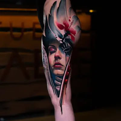 Abstract color realism tattoo of a woman's face on a thigh