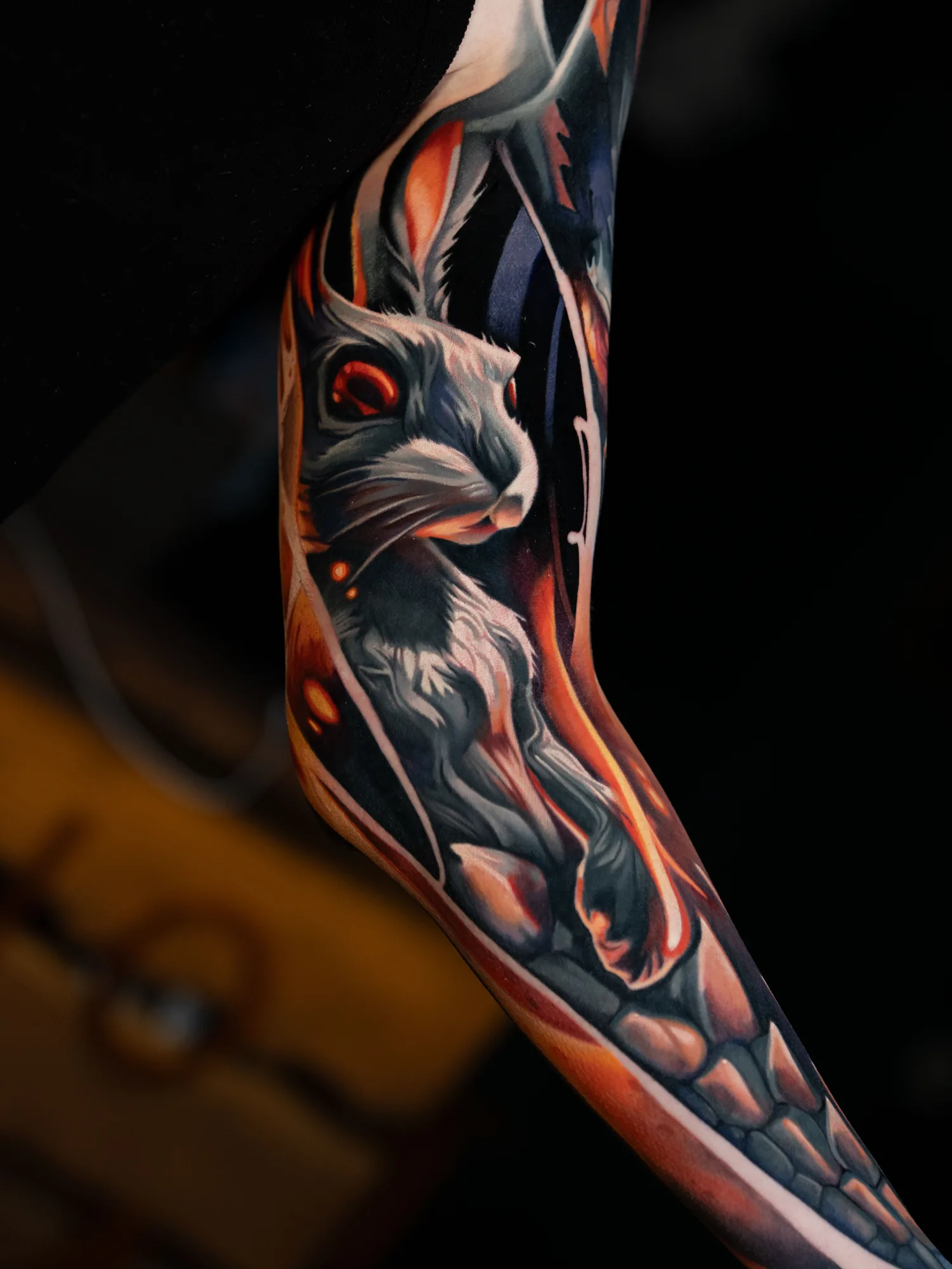 Color realism tattoo of a rabbit with dragon features on an arm