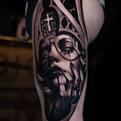 Black and grey realism tattoo of a woman framed by a gothic window on a thigh
