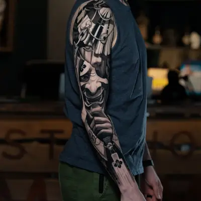 Healed black and grey realism sleeve of a geisha with a demon mask