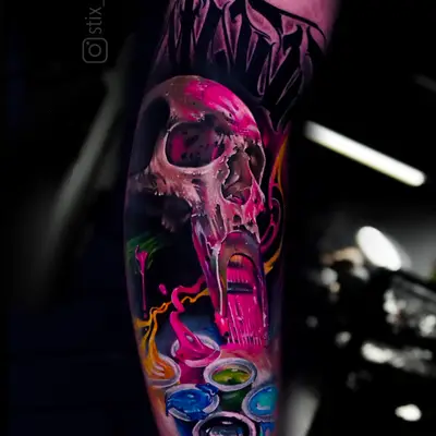 Colorful skull tattoo with paint splash effects on arm