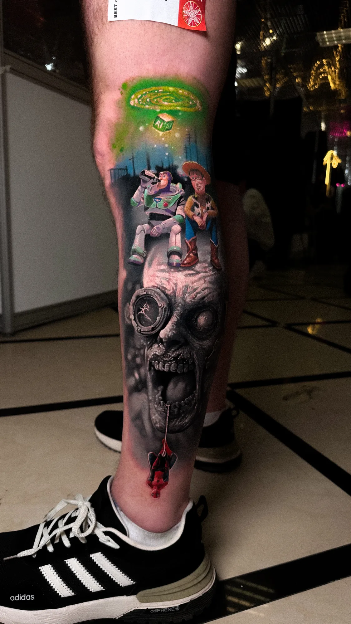 A vibrant tattoo depicting the impact of AI with Toy Story characters, Spider-Man, and a zombie-like face in a realism style.