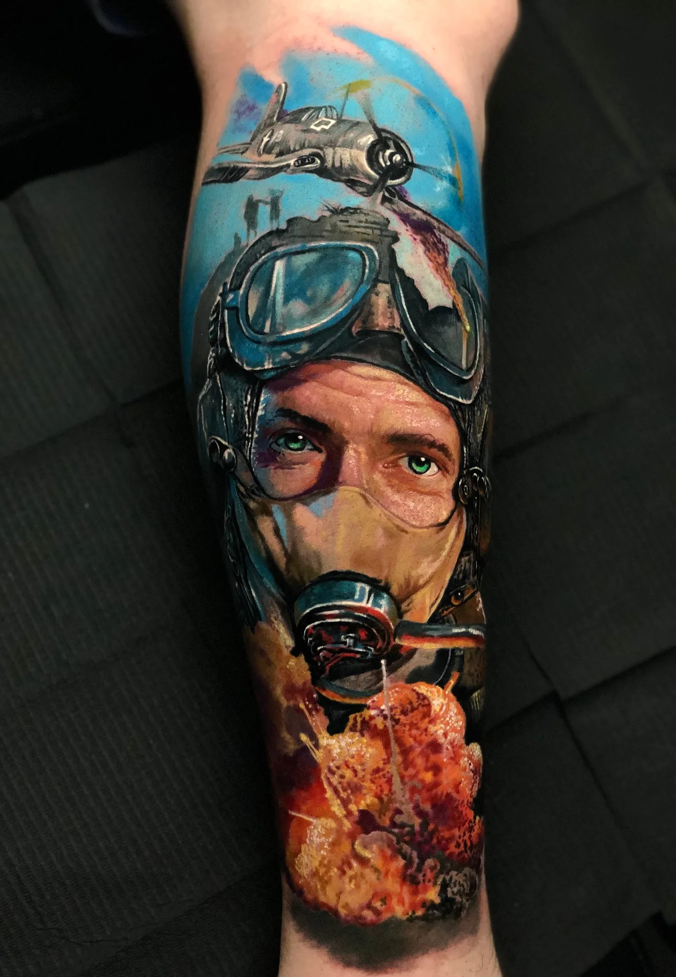 Color realism calf tattoo of a Second World War pilot in goggles and an oxygen mask with a bomber above