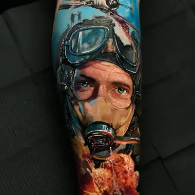 Color realism calf tattoo of a Second World War pilot in goggles and an oxygen mask with a bomber above