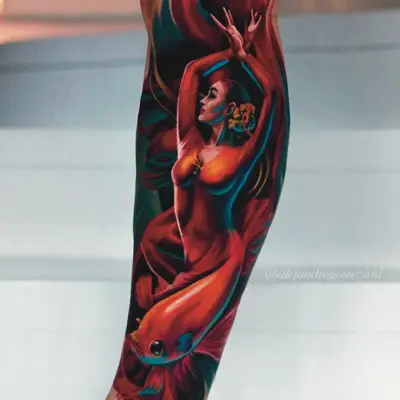 Color realism calf tattoo of a dancer with her arms raised and a red betta fish below
