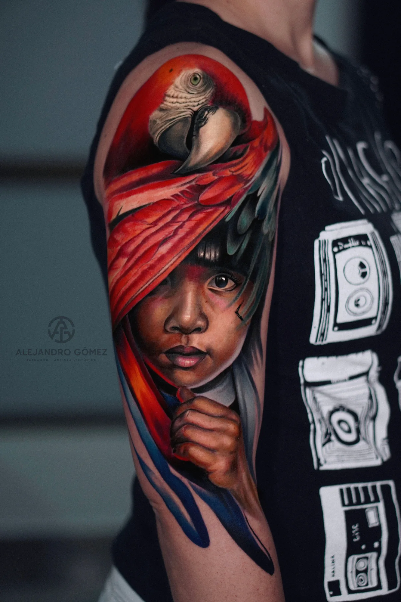 Color realism half sleeve of a child in a red headwrap with a scarlet macaw above