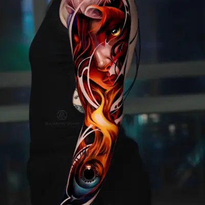 Color realism full sleeve with a portrait at the shoulder, flame down the arm and a blue eye at the wrist