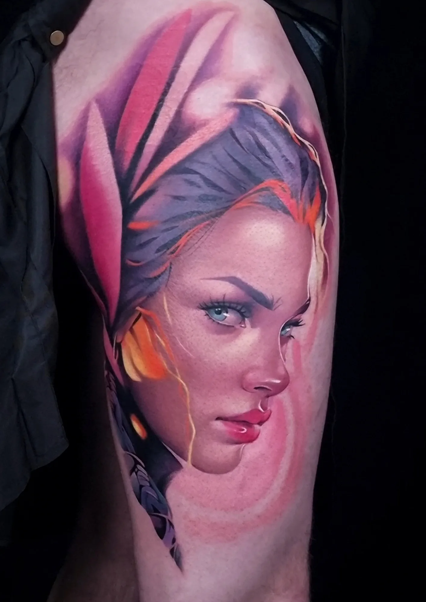 Color neorealist portrait of a woman in a pink and red headscarf with purple hair and orange highlights, tattooed on the thigh.