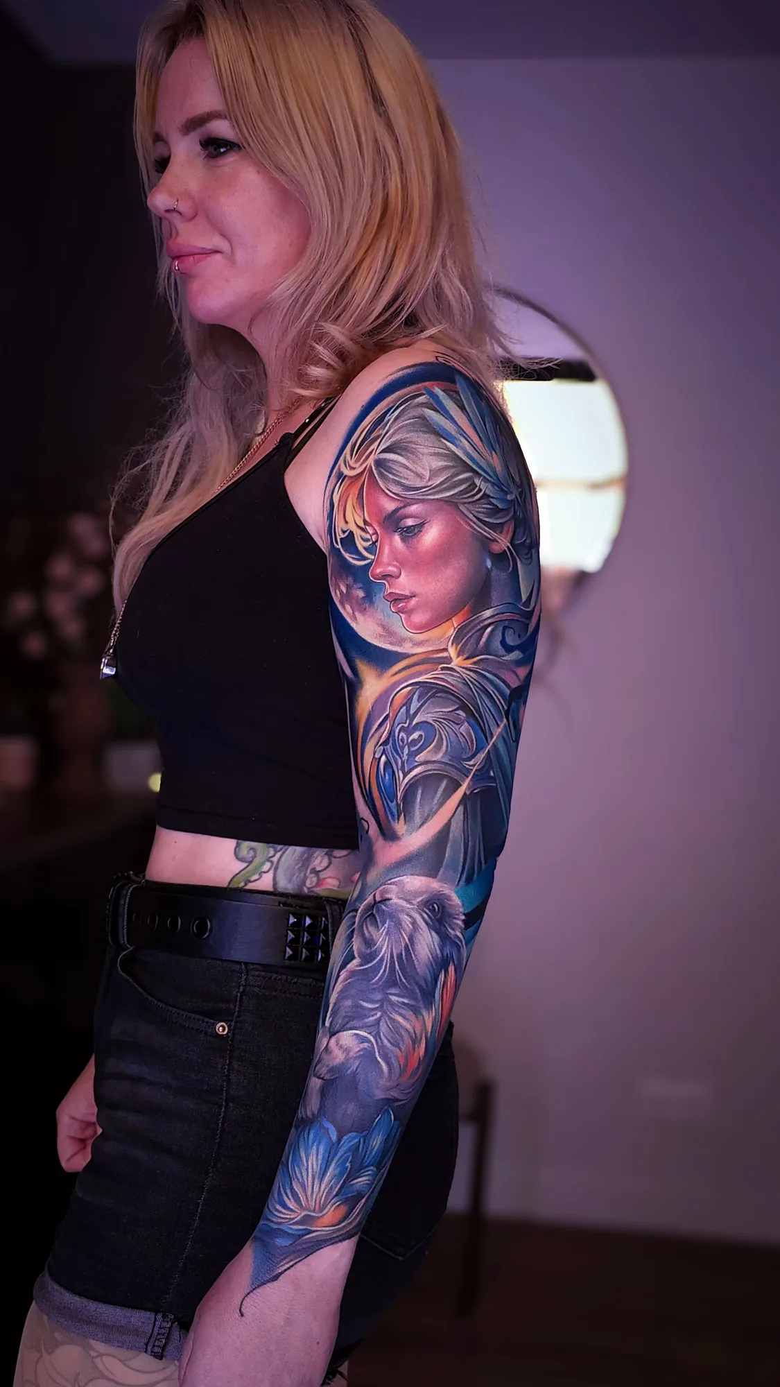 Colorful full sleeve tattoo featuring a portrait of a warrior goddess and a rabbit.