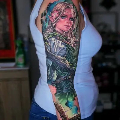 Full sleeve tattoo of an elvish archer with a storybook in full color.