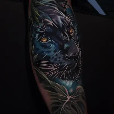 Color neorealist black panther face with amber eyes emerging from dark blue shadows and green jungle leaves, covering the forearm.