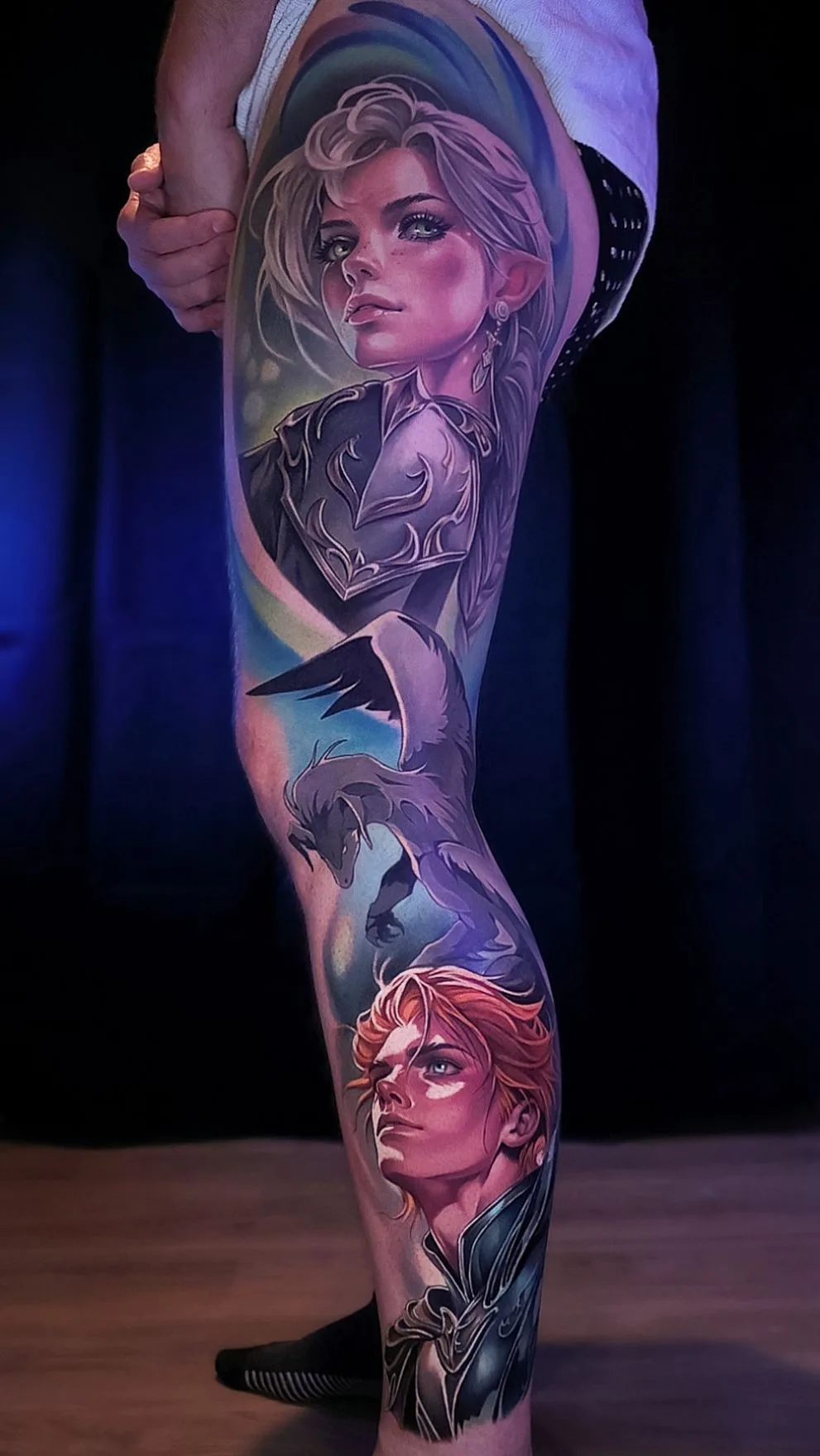 Full-length color neorealist leg panel from The Beginning After the End: Tessia in silver armor at the thigh, Sylvie as a small winged dragon at the knee, and Arthur with red hair on the calf.