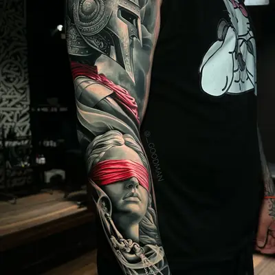 Tattoo of Spartan helmet and blindfolded Justice figure full sleeve