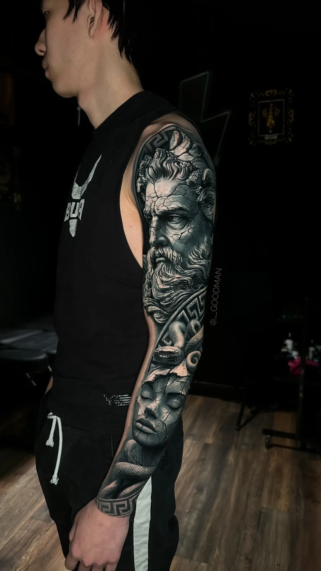 Realistic full sleeve tattoo of Greek god portrait and woman bust.